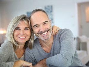Middle aged couple smiling at home