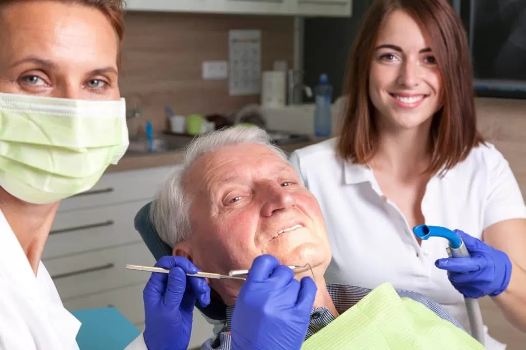 old man receiving help from an emergency dentist in Jupiter
